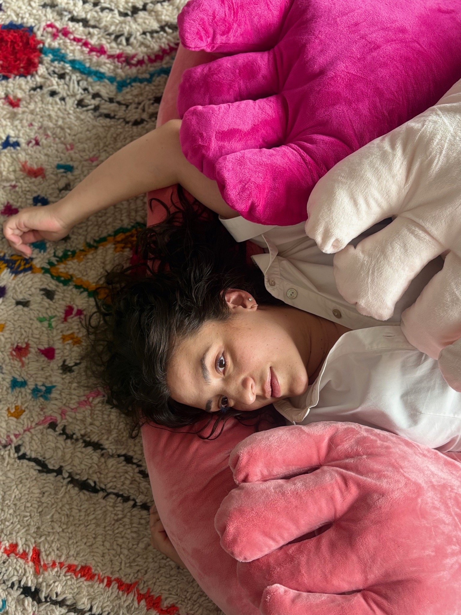 Woman resting among BIG HUG textile sculptures