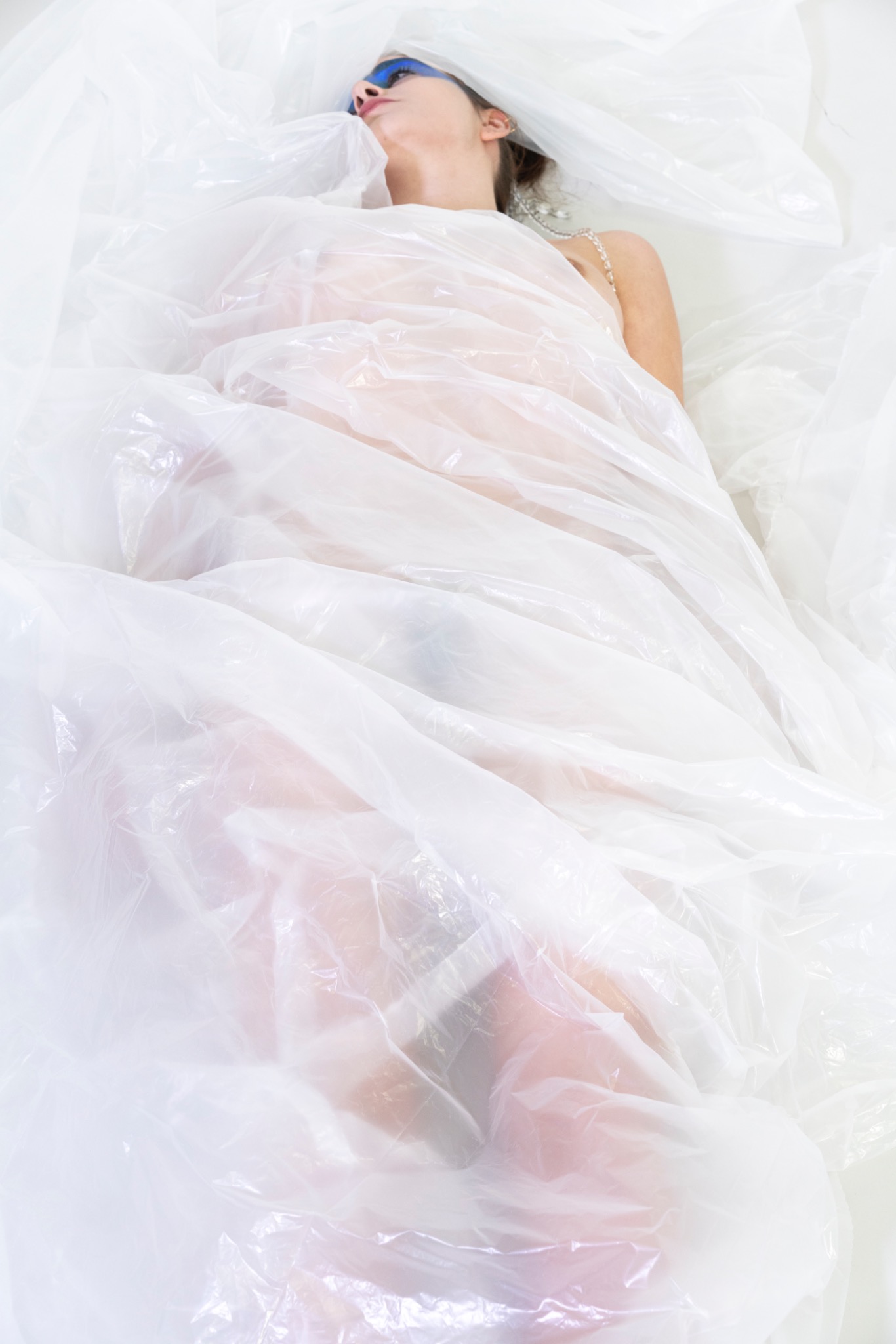 BLUE MADONNA body wrapped in translucent plastic