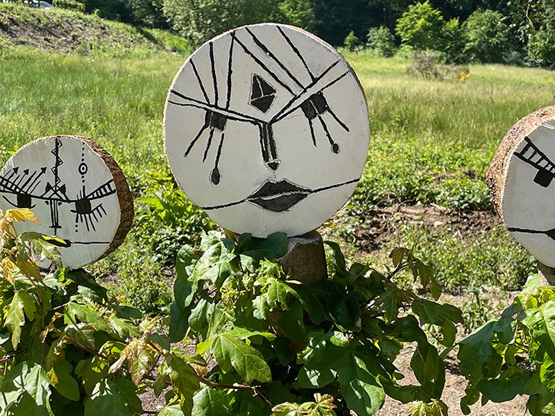 Forest face emerging among plants