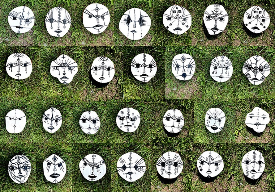 Black and white faces laid out on grass