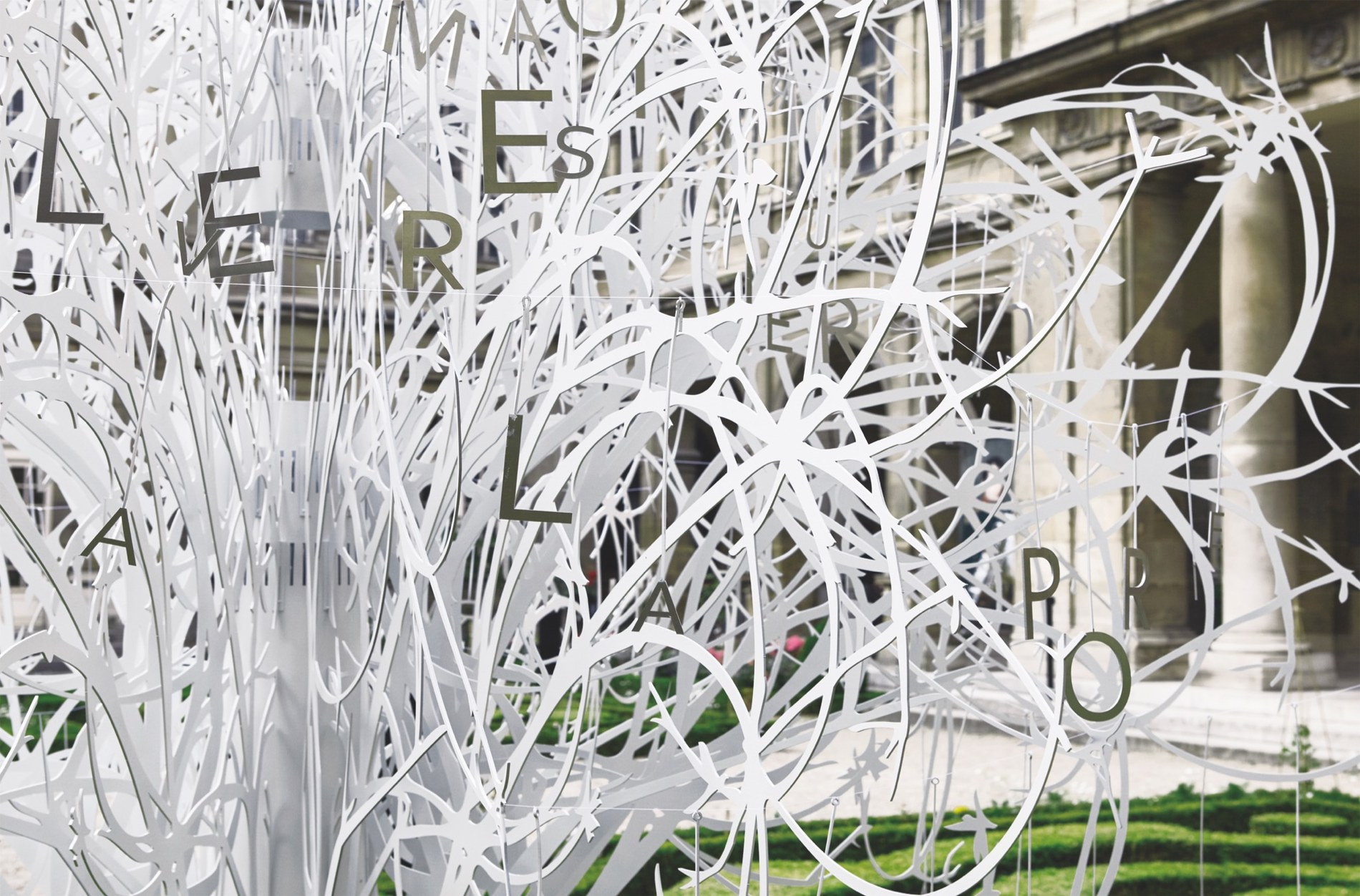 Letters suspended within L’Arbre à l’Être